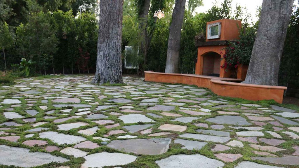 Olmos about us outdoor fireplace flagstone patio landscape